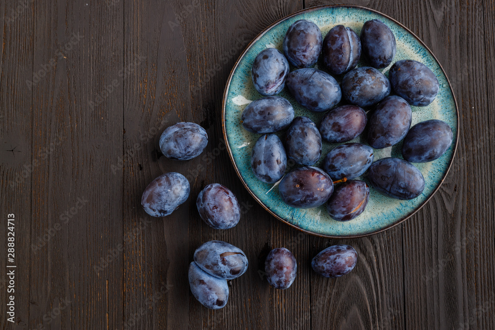 fresh ripe Plums in dish on table