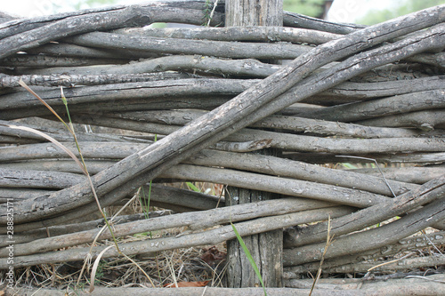 wicker crooked rural fence, country fence in mountains