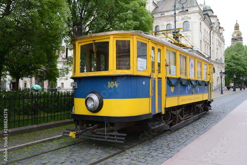 blue and yellow tram on the street of the ancient city close-up