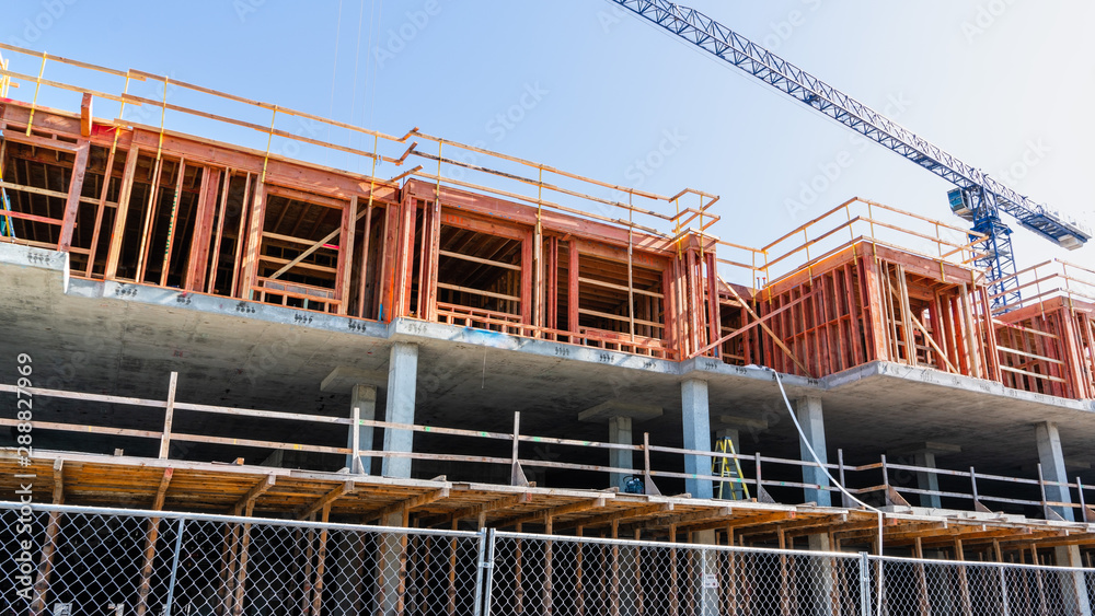 Multifamily residential building under construction in San Jose; the entire Silicon Valley and San Francisco Bay Area has faced a housing crisis, with increased housing costs, for several years Multifamily residential building under construction in San Jose; the entire Silicon Valley and San Francisco Bay Area has faced a housing crisis, with increased housing costs, for several years