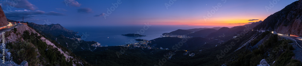 Fototapeta premium Budva riviera night coastline. Montenegro, Balkans, Adriatic sea. View from the top of the mountain road path.