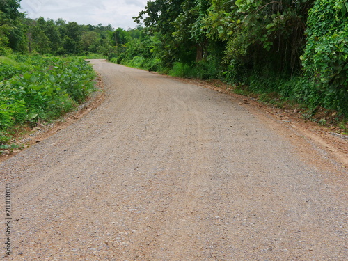 A dirt mixed with small granite road commonly seen in a rural area in the North of Thailand © OleCNX