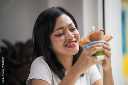 Asian young beautiful woman eating a dessert