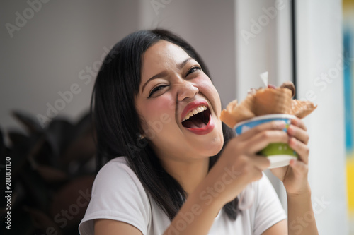 Asian beautiful young girl eat ice cream at outdoor of cafe