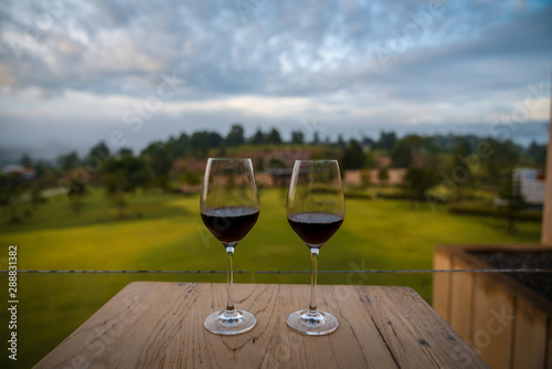 happy hipster lover couple guiding resting relaxing drinking wine together  at beautiful blue sky mountains hills green forest scenery garden park  grass field outdoors views Kanchanaburi  Thailand.