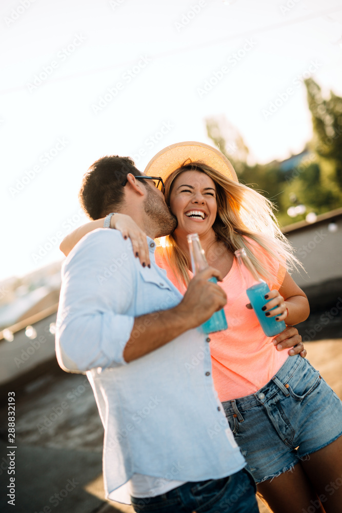 Fototapeta premium Happy young dancing couple having fun and enjoying party at summer