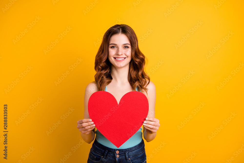 Photo of pretty lady holding large paper heart in hands wear tank-top and jeans isolated yellow background
