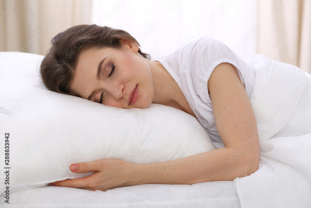 Beautiful young woman sleeping while lying in her bed. Concept of pleasant and rest reinstatement for active life Beautiful young woman sleeping while lying in her bed. Concept of pleasant and rest reinstatement for active life