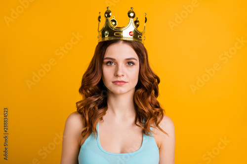 Photo of foxy not smiling lady wear tank-top and big golden crown isolated yellow background