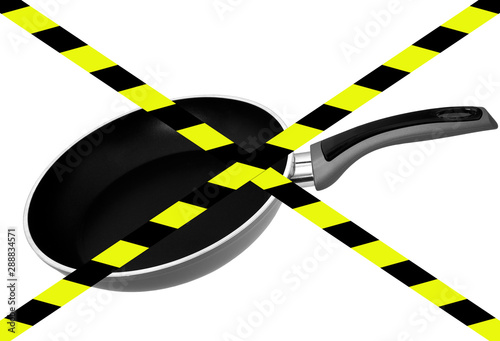Chemicals in cookware, non stick frying pan. PFAs ie polytetrafluoroethylene, perfluoroalkyl and polyfluoroalkyl aka PFOA,PFNA, PFTE. With danger tape. photo