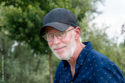 senior man in a baseball cap portrait © Philipimage