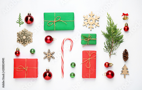 Flat lay composition with Christmas gifts and festive decor on white background