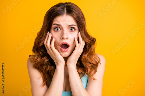Close up photo of horrified frightened girlfriend feared with something being about to cry and shout wearing turquoise singlet while isolated with vibrant yellow color background