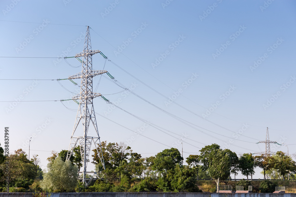 Steel transmission tower of overhead power line agains of sky