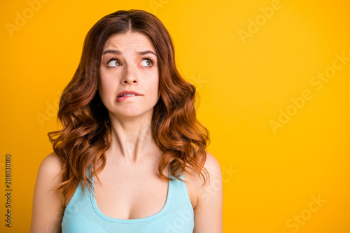 Close up copyspace photo of astonished feared cute pretty nice girlfriend pondering over how to correct mistake wearing turquoise tank-top while isolated with yellow bright color background