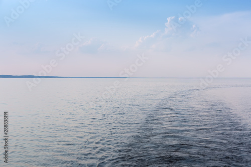 Water surface of reservoir with far horizon in summer evening photo