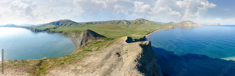 Wide panorama of hilly terrain on seashore from the promontory