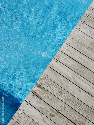 wooden platform on swimming pool background. top view. Procurement, a template for design with place for text. Old boards and a lake copy space. © mishadp