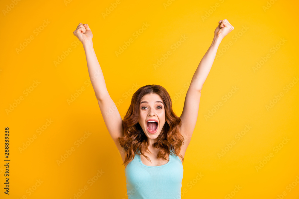 Photo of trendy curly beautiful attractive cheerful cute nice charming childish rejoicing girlfriend wearing turquoise singlet while isolated with yellow vibrant color background