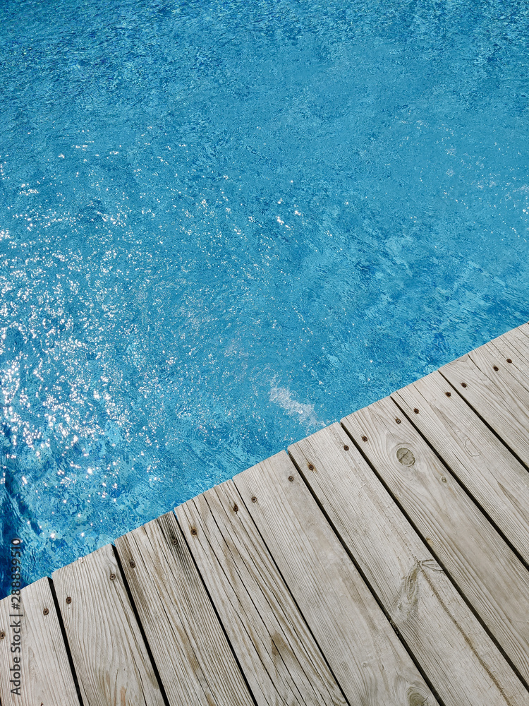 wooden platform on swimming pool background. top view. Procurement, a template for design with place for text. Old boards and a lake copy space.
