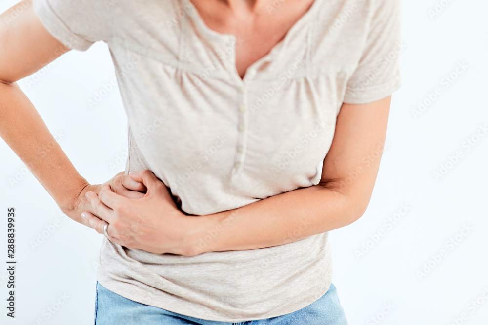 Woman with stomach/ hip issues / problems on the white background. Woman with stomach/ hip issues / problems on the white background.