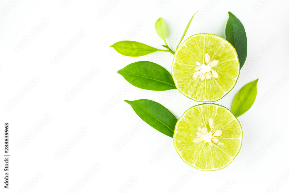 top view of fresh juicy sliced lime with green leaves on white background and copy space for text. top view of fresh juicy sliced lime with green leaves on white background and copy space for text.