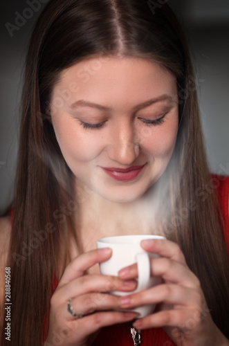 young woman with an aromatic coffee