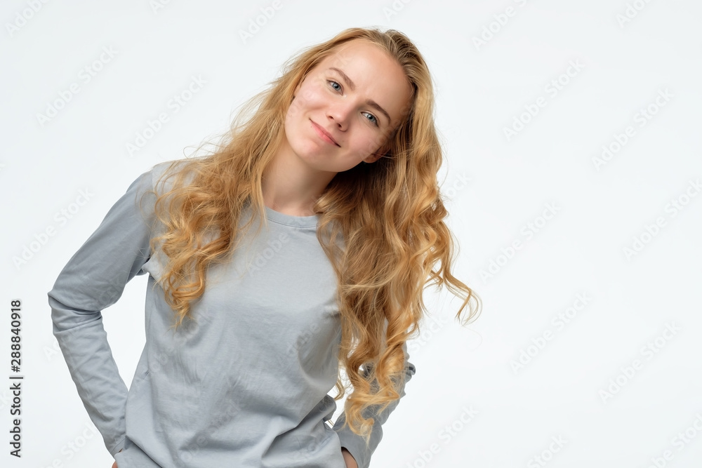 Young beautiful happy woman looking at camera with smile. Positive facial human emotion. Young beautiful happy woman looking at camera with smile. Positive facial human emotion.