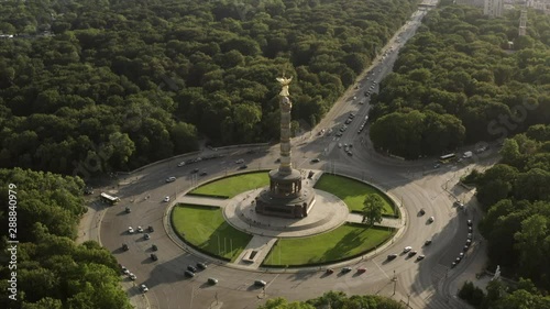 The Siegessäule in Berlin, Germany in an aerial shot. The roundabout at the statue can be seen and the drone is flying slowly backwards. photo