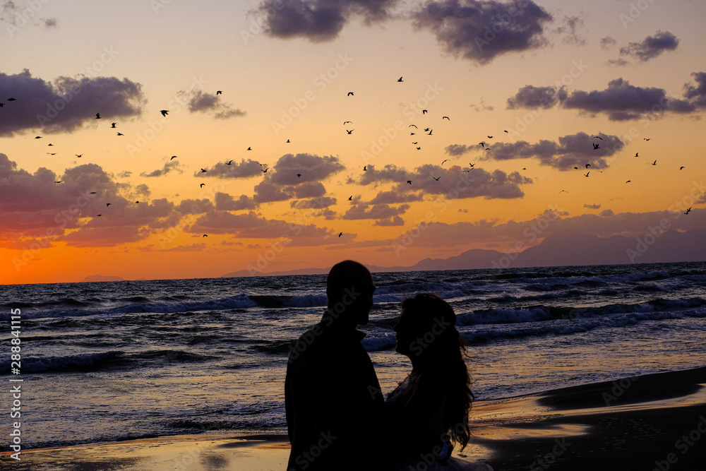 Couple in love, people shadows silhouette over Inspirational sea sunset atmosphere