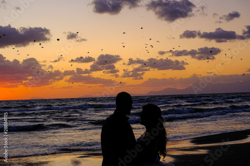 Couple in love, people shadows silhouette over Inspirational sea sunset atmosphere