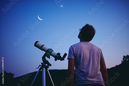 Photographie Astronomer with a telescope watching at the stars and Moon
