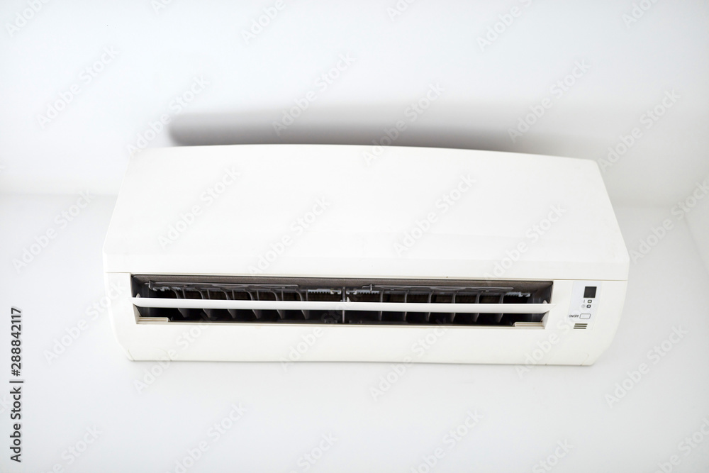 Moder air condition unit on a white wall inside the living room. Moder air condition unit on a white wall inside the living room.