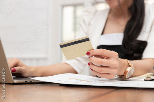 Freelancer business woman using computer laptop and credit cart to shopping online in cafe.