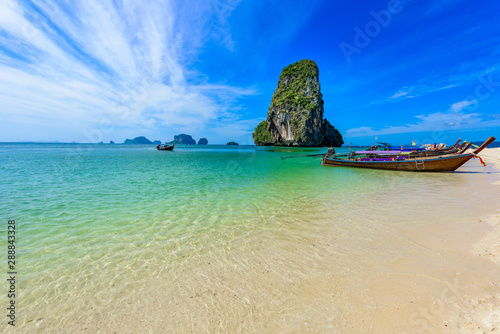 Ao Phra Nang Beach - Thai traditional wooden longtail boat on Railay Peninsula in front of Limestone karst rocks, close to Ao Nang, Krabi province, Andaman Sea, Thailand