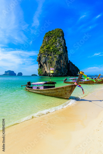 Ao Phra Nang Beach - Thai traditional wooden longtail boat on Railay Peninsula in front of Limestone karst rocks  close to Ao Nang  Krabi province  Andaman Sea  Thailand