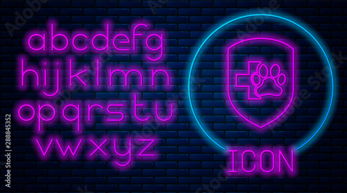 Glowing neon Animal health insurance icon isolated on brick wall background. Pet protection icon. Dog or cat paw print. Neon light alphabet. Vector Illustration