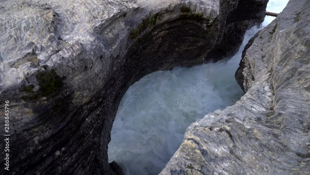 Glacial Waters Gushing Through A Rock Crevasse CLOSE UP. Natural Bridge at Yoho National Park Glacial Waters Gushing Through A Rock Crevasse CLOSE UP. Natural Bridge at Yoho National Park