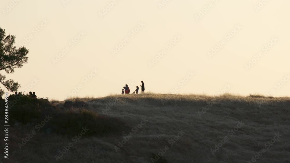 A family playing and relaxing on a brightly lit mountain ridge. On Mount Tamalpais, California. A family playing and relaxing on a brightly lit mountain ridge. On Mount Tamalpais, California.
