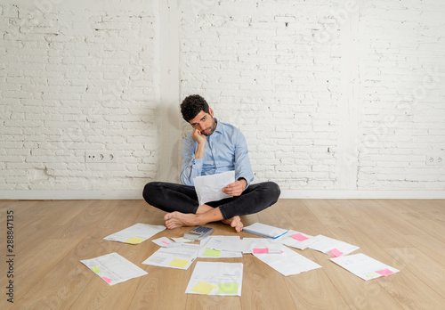 Lifestyle portrait of stressed overwhelmed young man managing own investment business finances