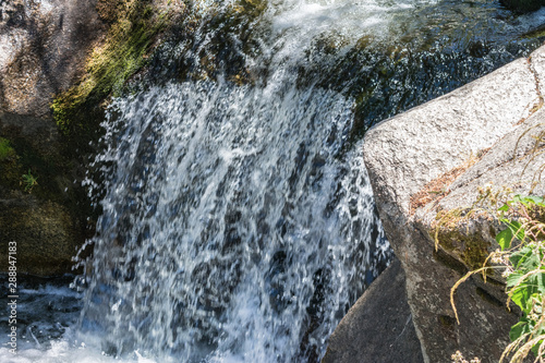 mountain river waterfall between stones photo