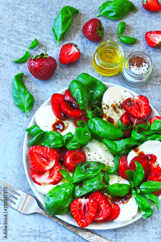 Summer salad with strawberries and mozzarella. Italian caprese salad with strawberries.