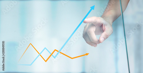Hand touching a graphs of financial indicator chart