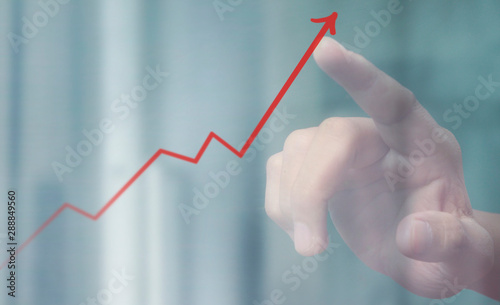Hand touching a graphs of financial indicator chart