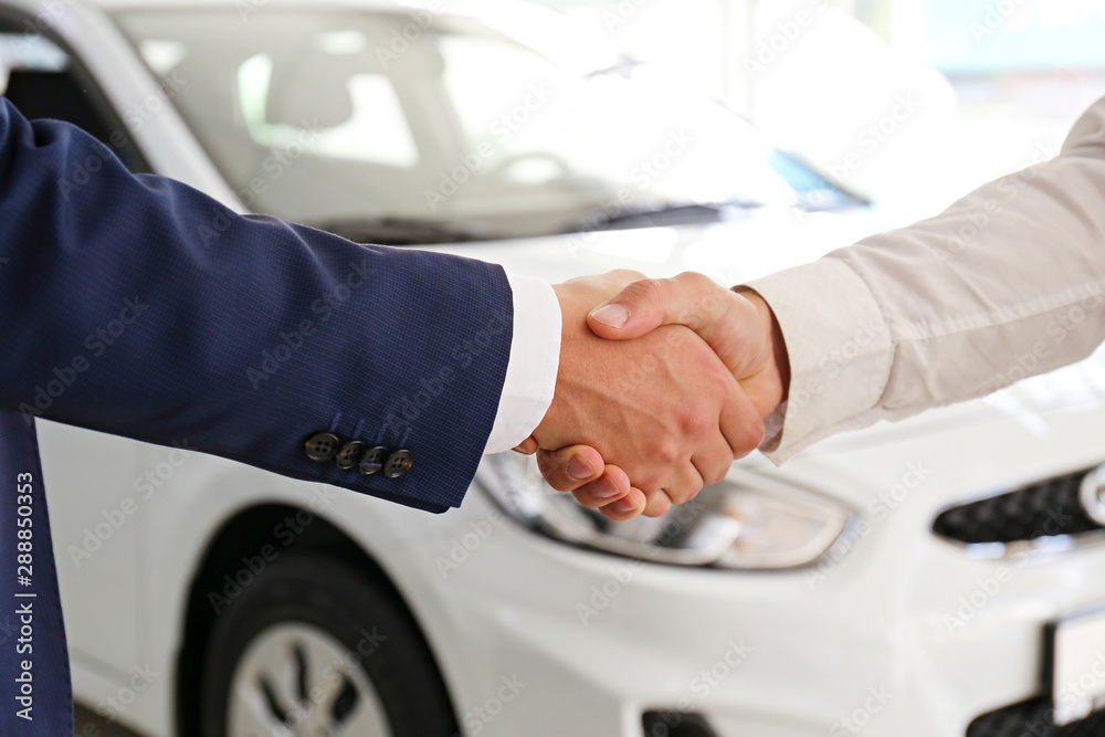 Car dealership sales person at work concept. Portrait of young sales