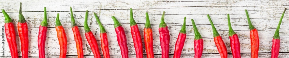 banner of frame of red Chile pepper on white wooden table
