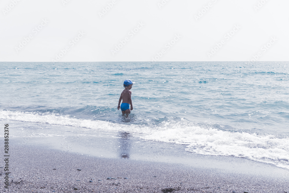 Adorable little blond kid boy having fun on tropical beach. Healthy lifestyle, active parent, people water outdoor adventure, swimming beach summer holidays with child. Adorable little blond kid boy having fun on tropical beach. Healthy lifestyle, active parent, people water outdoor adventure, swimming beach summer holidays with child.