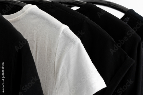 Fototapeta Naklejka Na Ścianę i Meble -  black and white color tone clothes on hangers in wardrobe. Woman minimalist wardrobe. Horizontal banner