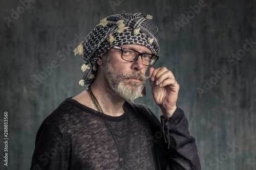 Old fashion man, good looking. Hottabych twists mustache photo