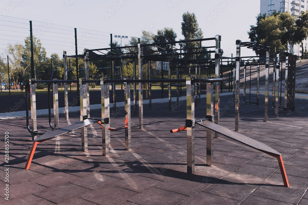 Modern outdoor gym in the residential area. Outdoor exercise equipment for workout. Sports ground.